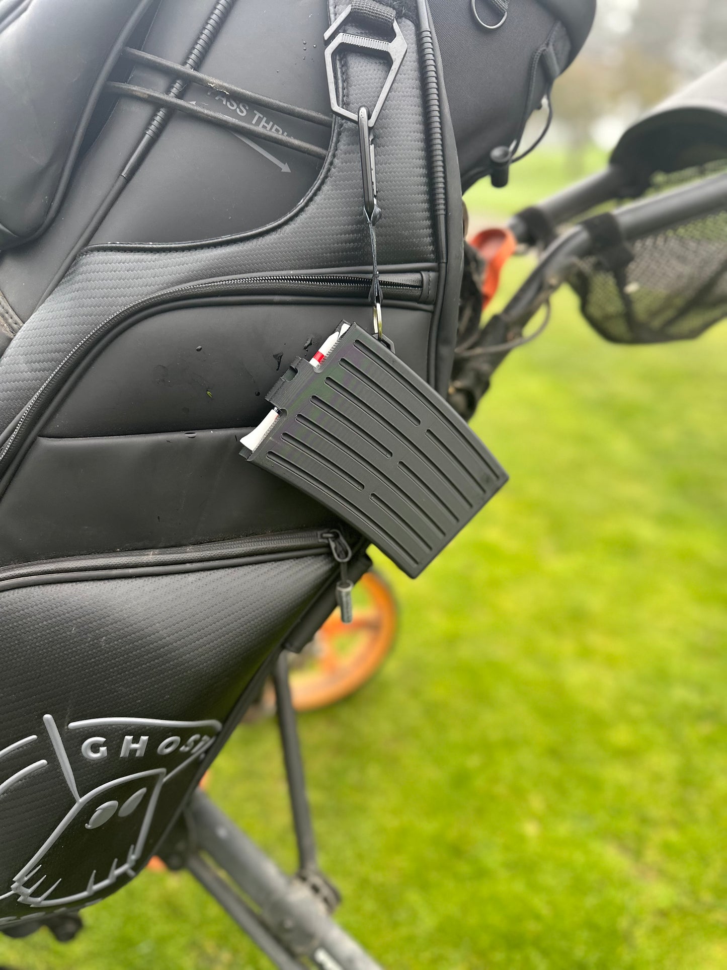 GTee-Magz golf tee dispenser clipped to golf bag, clip-on tee holder holding 10 golf tees, premium golf accessory and golf gift